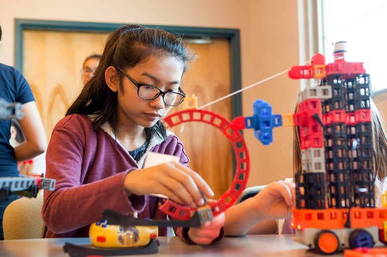 Middle school girl applying the scientific method to her work with Kid Spark ROK Blocks