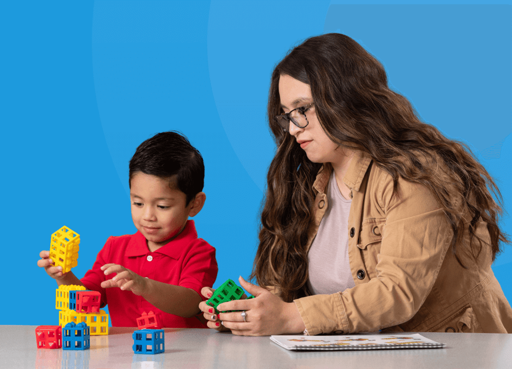 teacher-guiding-student-while-playing-toys