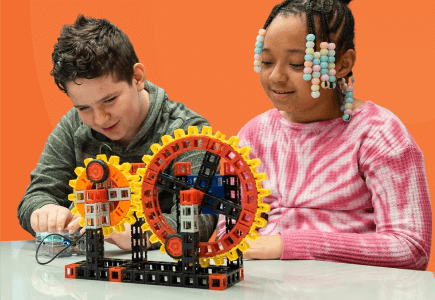 two-students-showing-creativity-orange-background