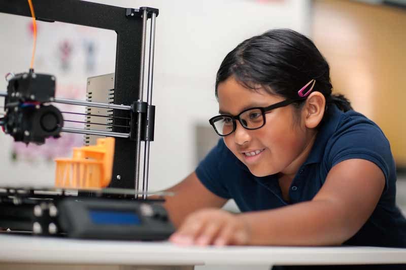 Elementary School Student Learning About Robotics in a STEM Lab