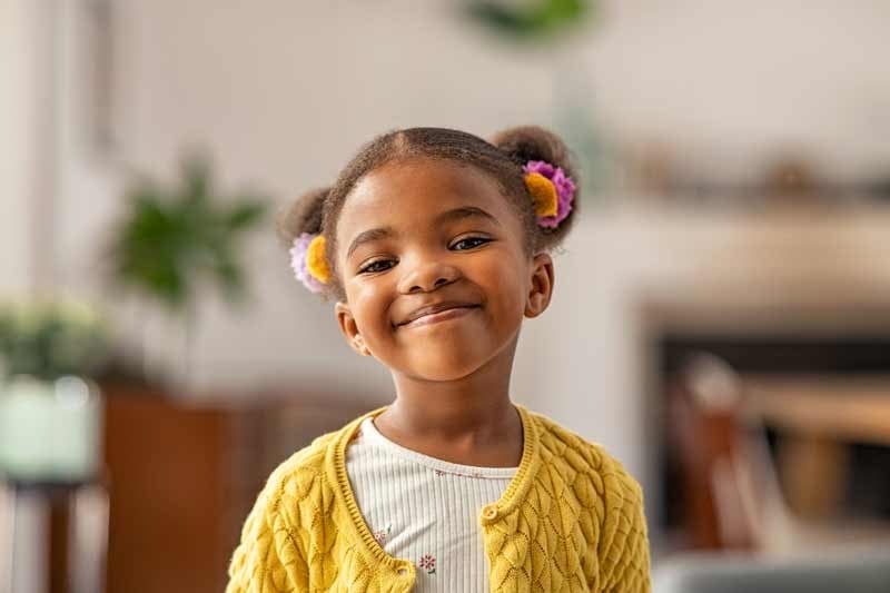 Kindergarten student smiling after achieving STEM learning experiences 